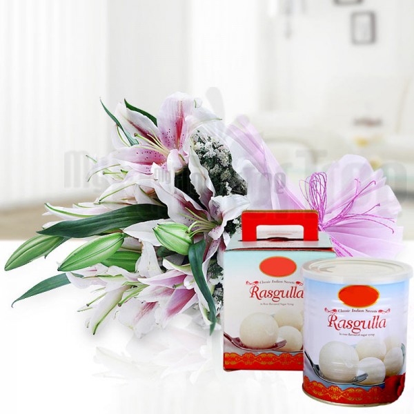  6 Oriental Pink Lilies in Pink and White Paper Packing, Pink Rafia Bow with Rasgullas (1 Kg)